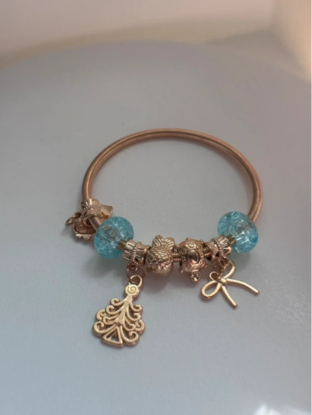 Light blue, gold tone charm bracelet